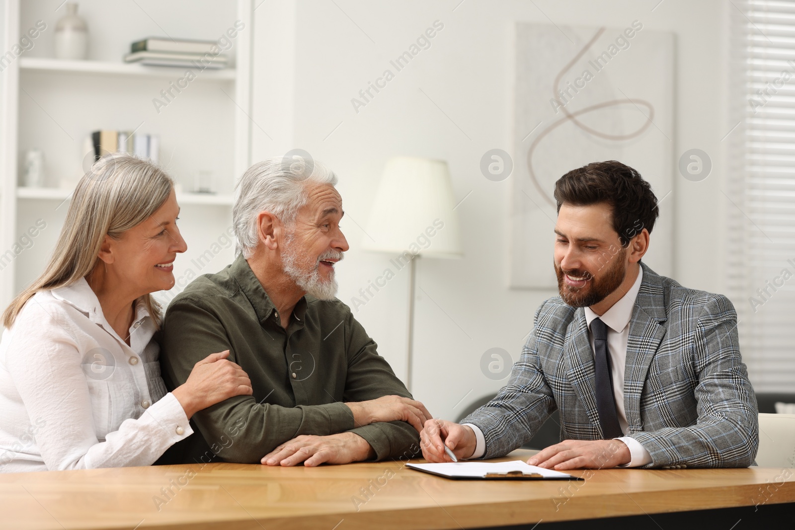 Photo of Notary consulting senior couple about Last Will and Testament in office