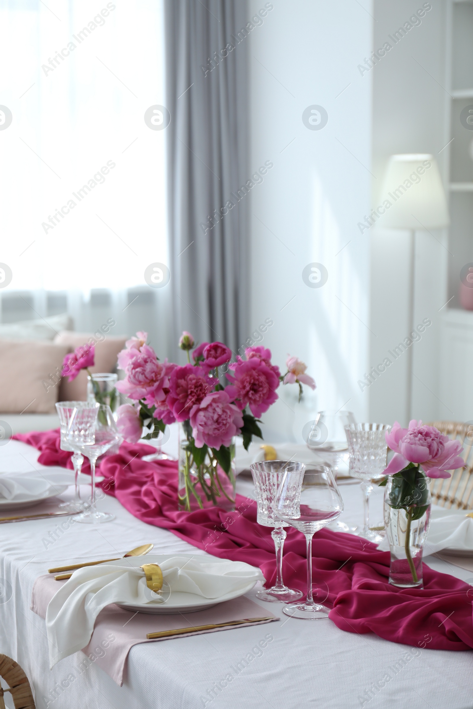 Photo of Beautiful table setting with pink peonies in dining room