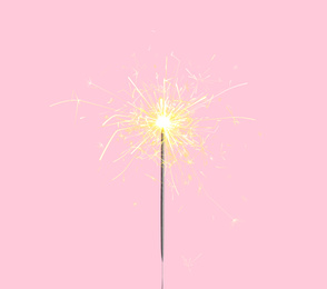 Image of Beautiful sparkler burning on pink background. Party decor