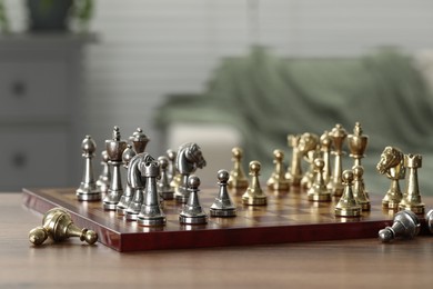 Chess board with pieces on wooden table, selective focus. Space for text