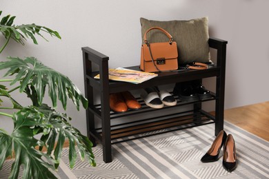 Hallway interior with stylish furniture, shoes and accessories