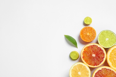 Composition with different citrus fruits on white background, top view