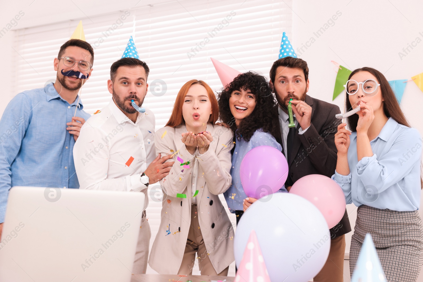 Photo of Coworkers having fun during office party indoors