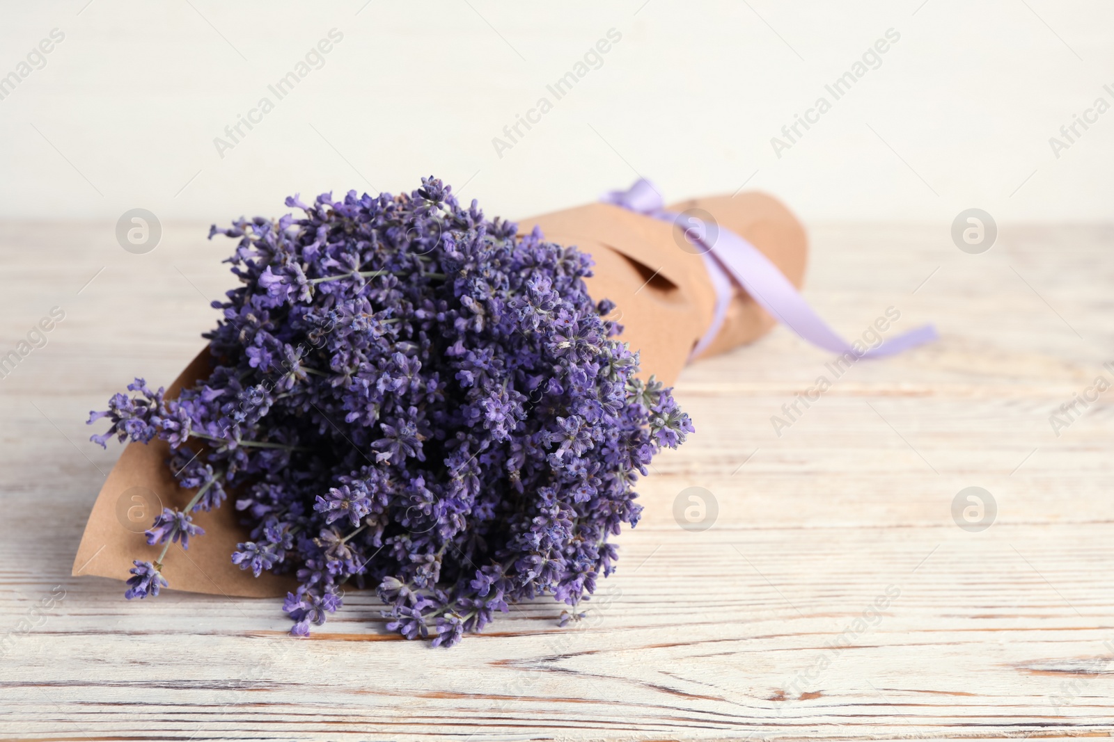 Photo of Beautiful lavender bouquet on white wooden table