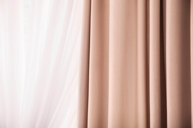 Window with elegant curtains indoors, closeup view
