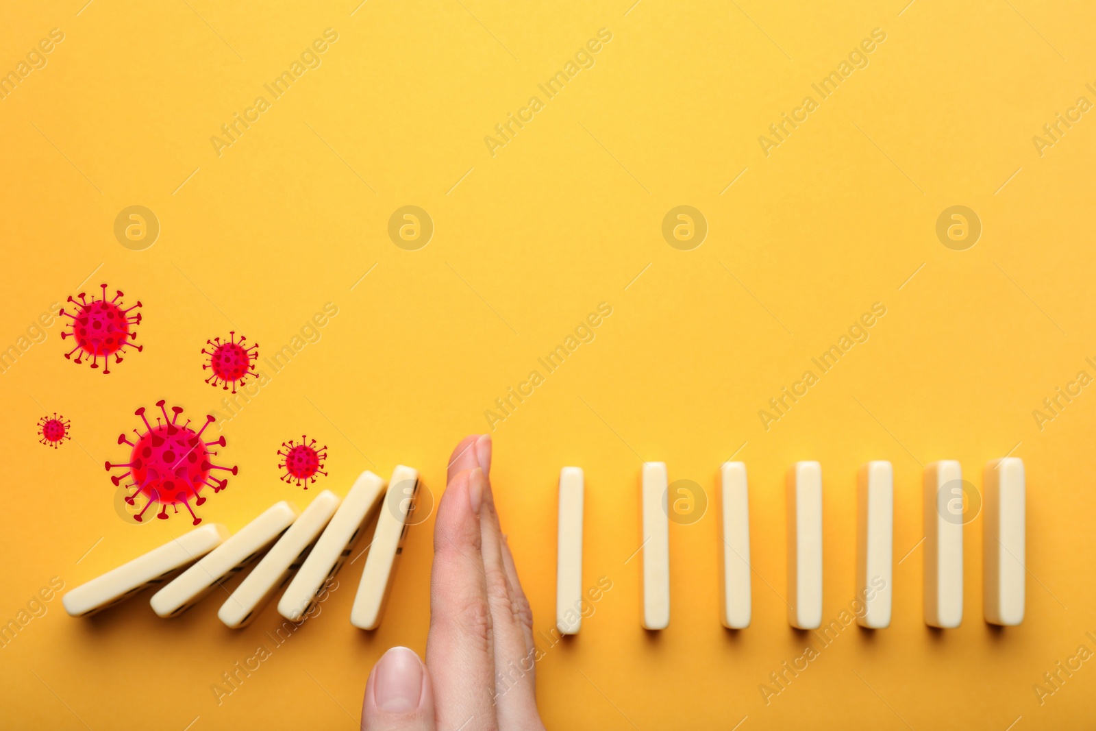 Image of Woman stopping domino effect on yellow background, top view. Prevent spreading of coronavirus