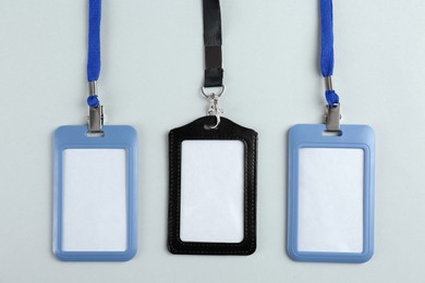 Blank badges on light background, flat lay. Mockup for design