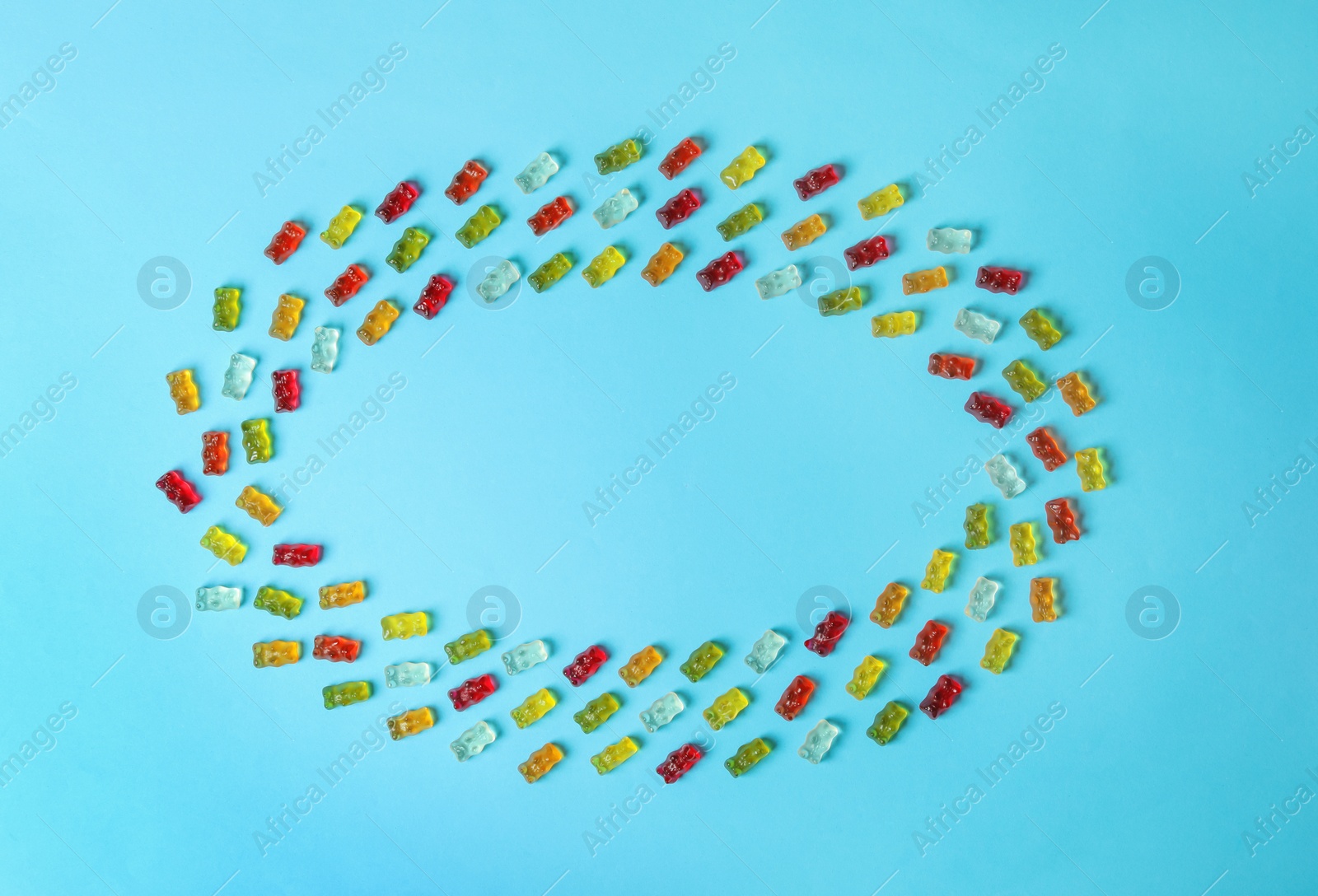 Photo of Flat lay composition with delicious jelly bears on color background. Space for text