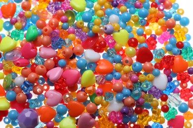 Photo of Pile of bright colorful beads as background, closeup