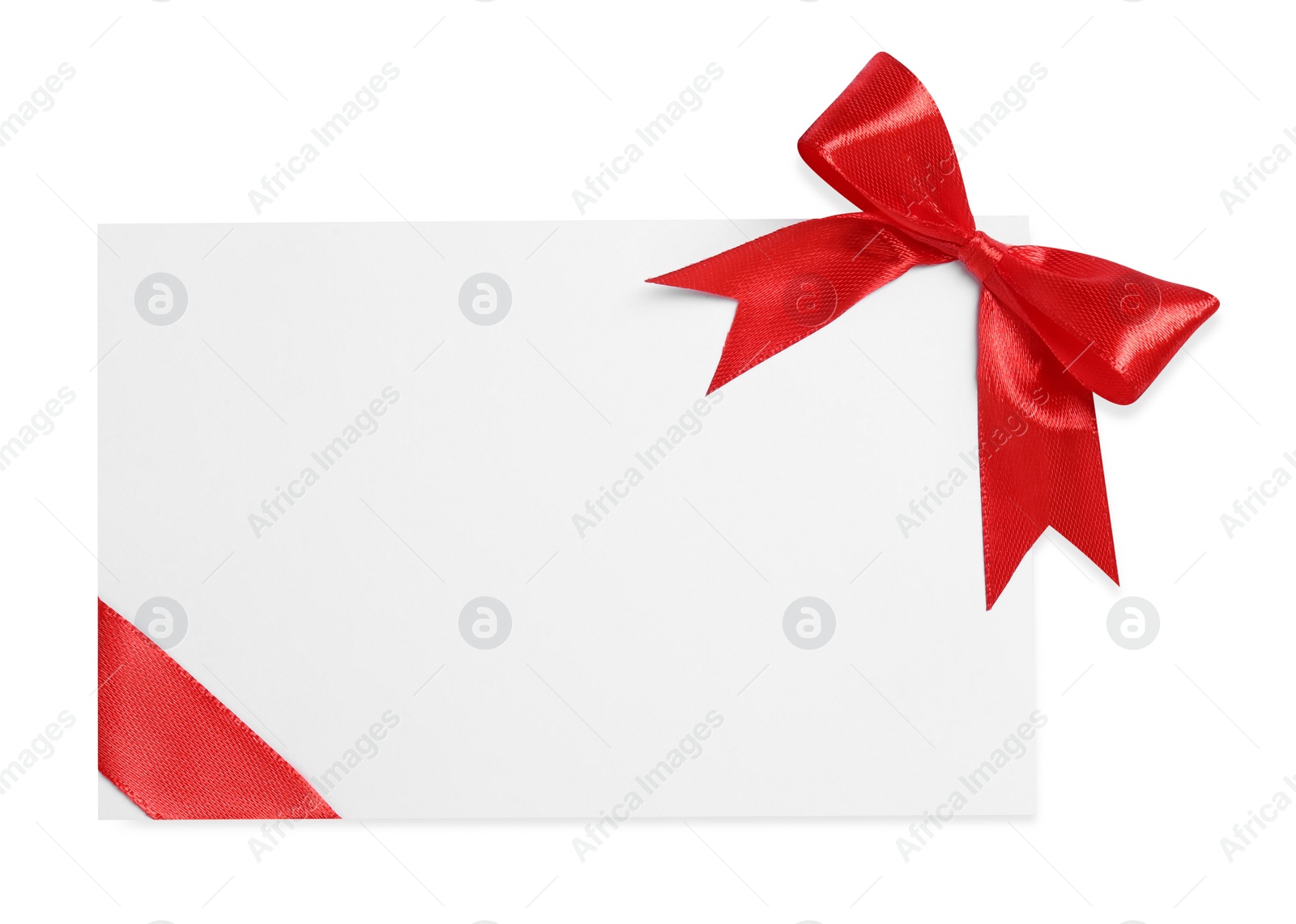 Photo of Blank gift card with red bow isolated on white, top view