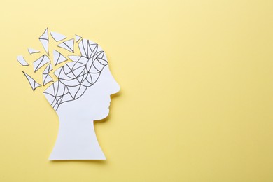 Photo of Human head with brain pieces made of paper on beige background, top view and space for text. Dementia concept