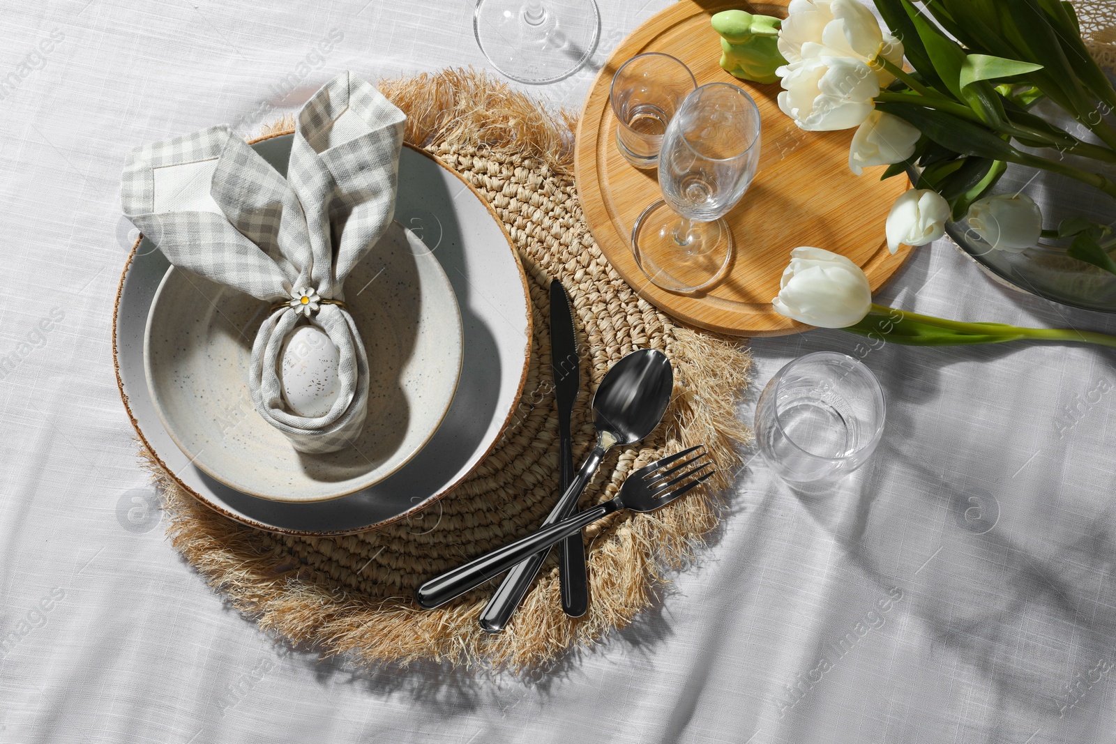 Photo of Easter table setting with bunny ears made of egg and napkin, above view