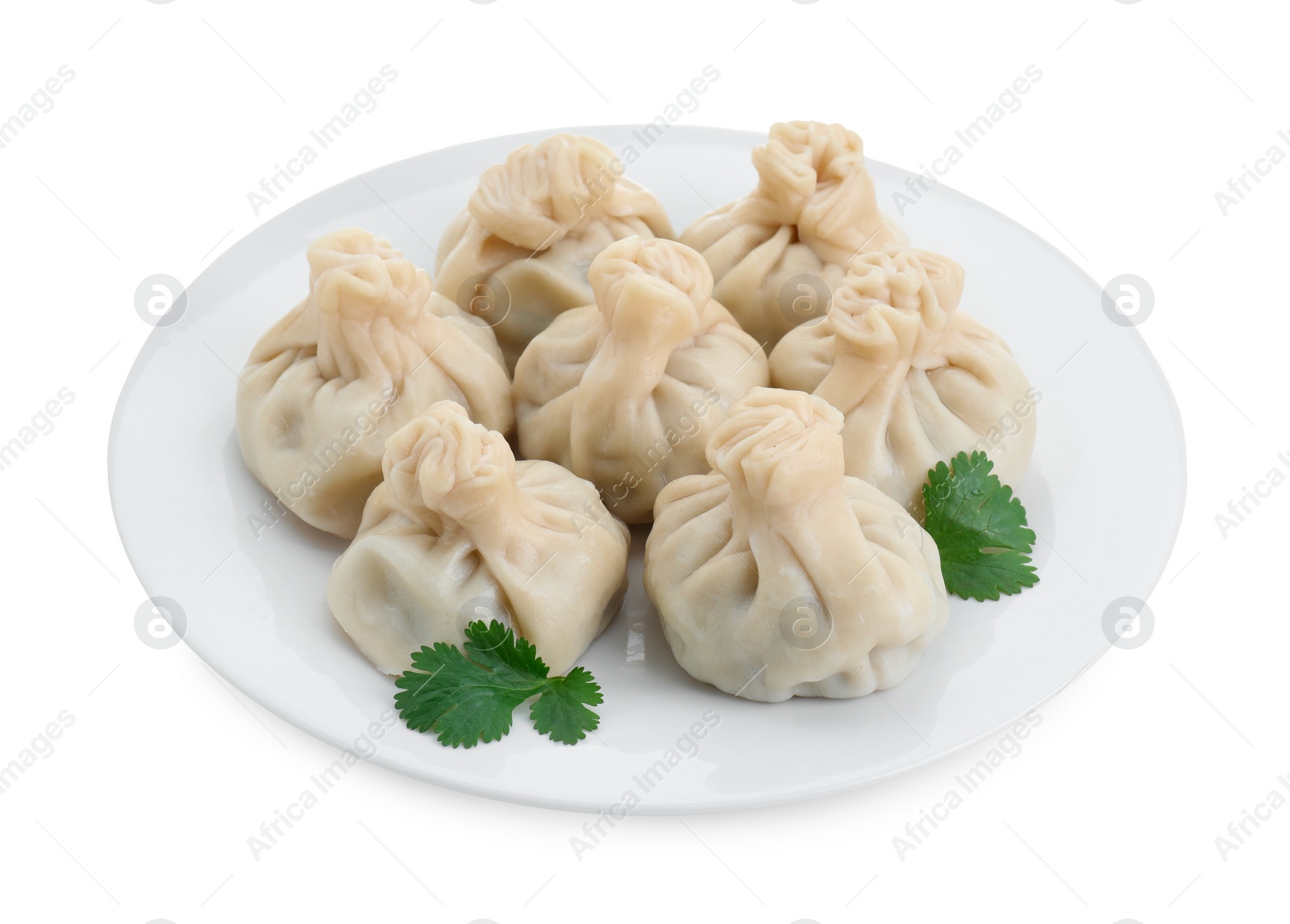 Photo of Plate with many tasty khinkali (dumplings) and parsley isolated on white. Georgian cuisine