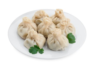 Plate with many tasty khinkali (dumplings) and parsley isolated on white. Georgian cuisine