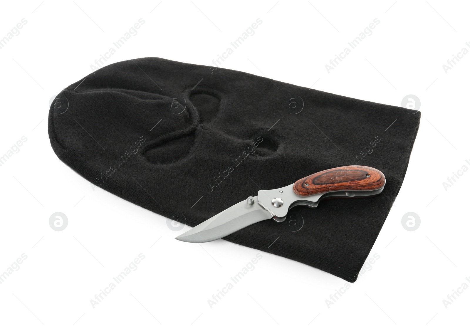 Photo of Black knitted balaclava and knife on white background