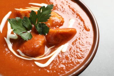 Photo of Bowl of delicious butter chicken on table, closeup. Traditional indian Murgh Makhani