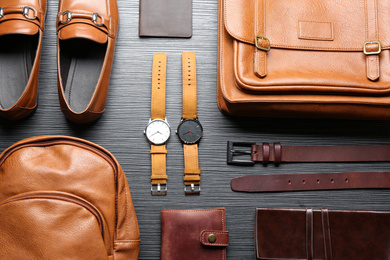 Photo of Flat lay composition with leather bags, shoes and accessories on grey wooden table