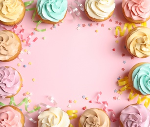 Flat lay composition with delicious birthday cupcakes and space for text on color background