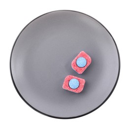 Photo of Grey plate with dishwasher detergent tablets on white background, top view