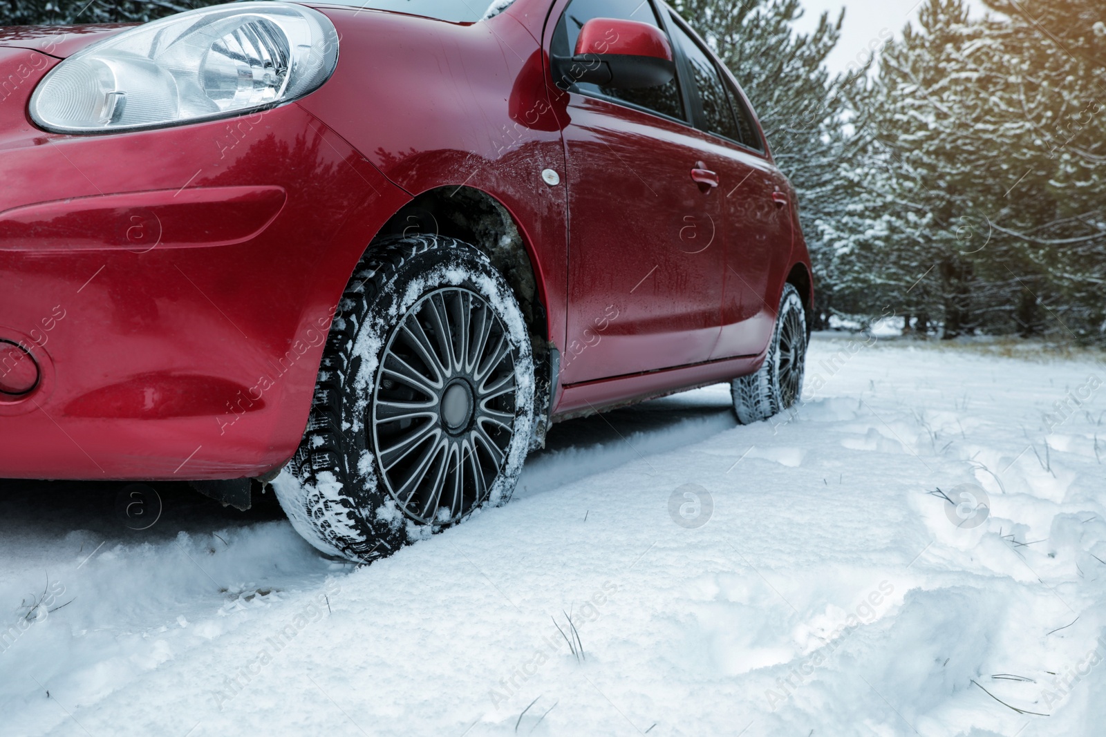 Photo of Snowy country road with car on winter day. Space for text