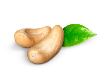 Tasty cashew nuts and fresh green leaf on white background 