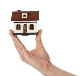 Woman holding house model on white background