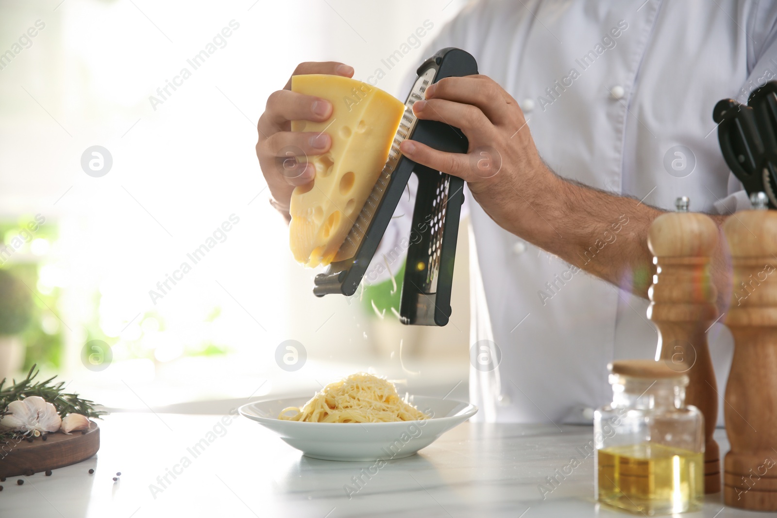 Photo of Chef cooking at table in kitchen, closeup