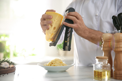 Chef cooking at table in kitchen, closeup