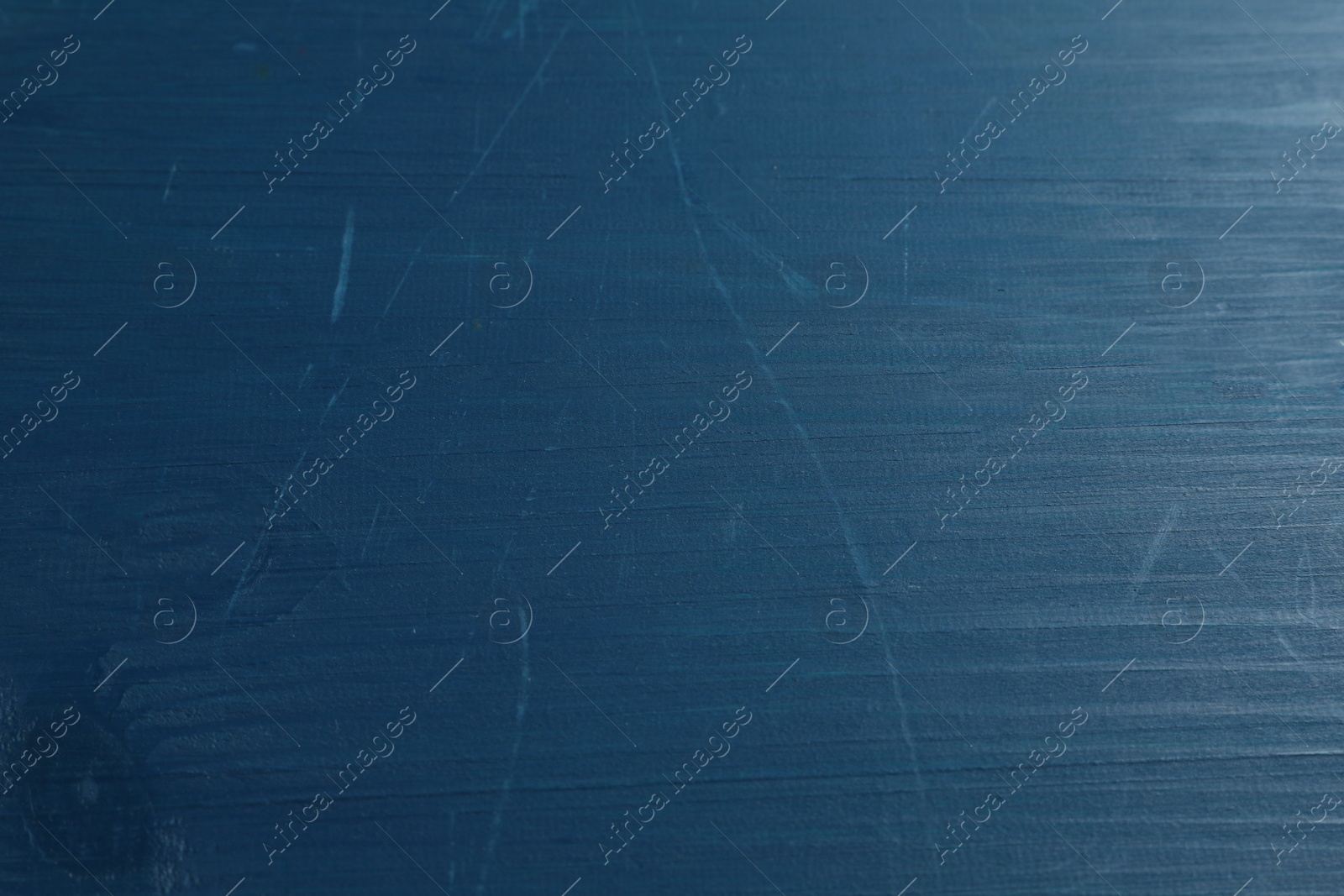 Photo of Old blue wooden surface with scratches as background, closeup