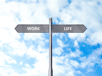 Image of Signpost against beautiful blue sky. Concept of balance between work and life