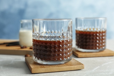 Glass with cold brew coffee on table