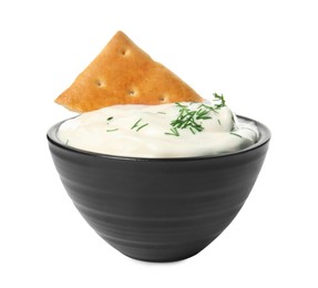 Photo of Tasty creamy dill sauce with cracker in bowl isolated on white