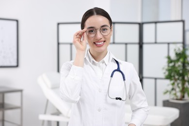 Medical consultant with glasses and stethoscope in clinic