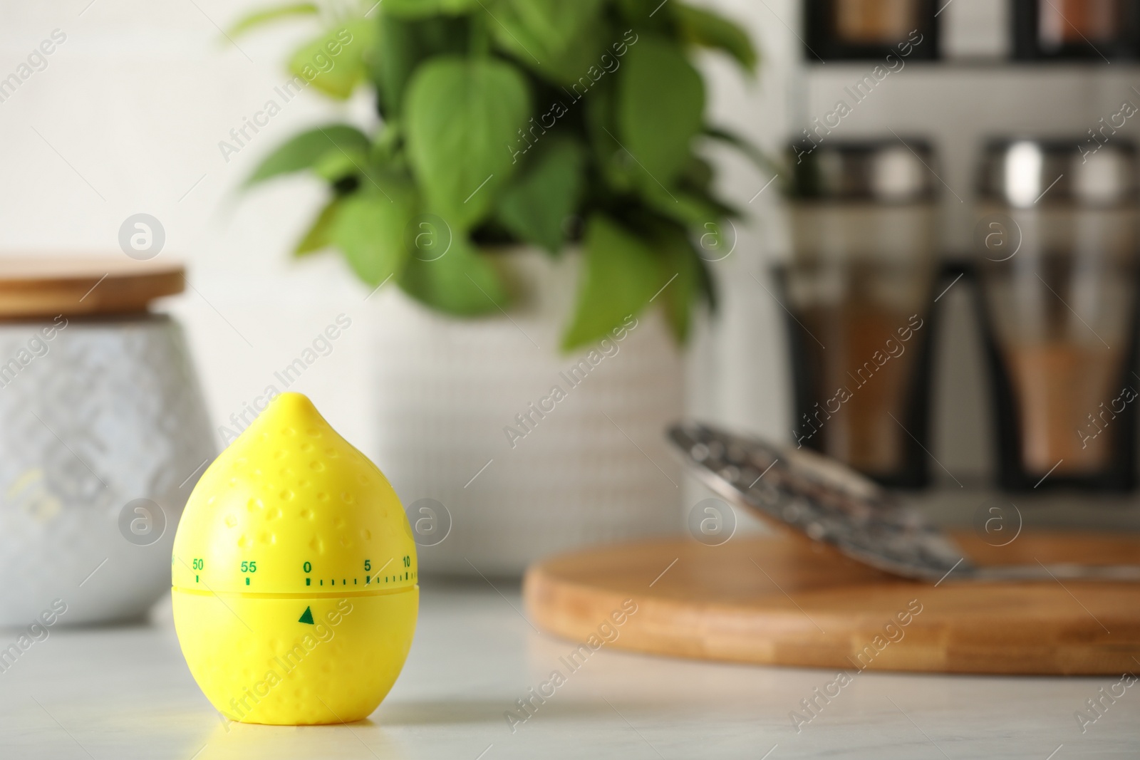 Photo of Kitchen timer in shape of lemon on white table. Space for text