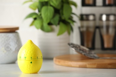 Photo of Kitchen timer in shape of lemon on white table. Space for text
