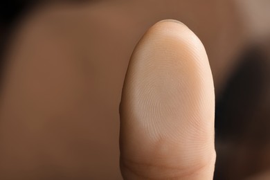 Woman pressing finger to surface, closeup view. Scanning fingerprint