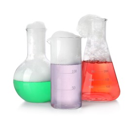 Photo of Laboratory glassware with colorful liquids isolated on white. Chemical reaction