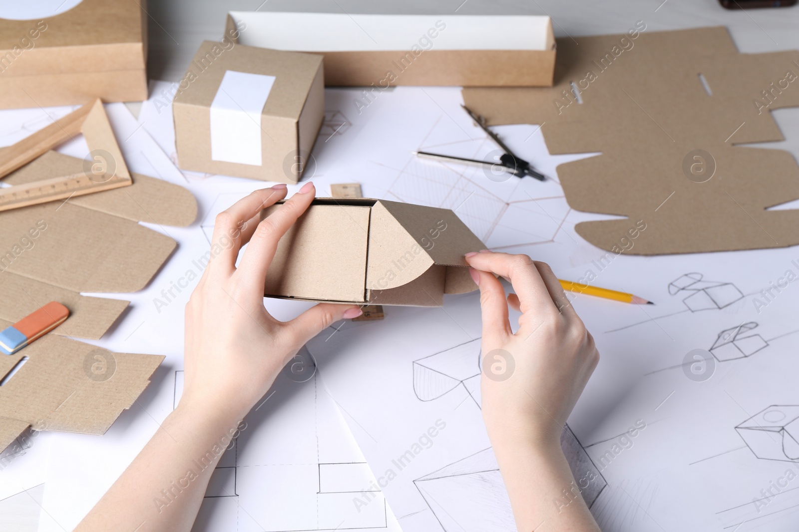 Photo of Woman creating packaging design at table, closeup