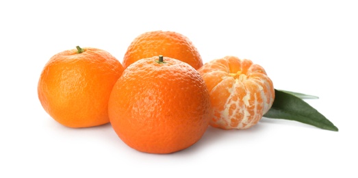 Fresh ripe tangerines with green leaves on white background