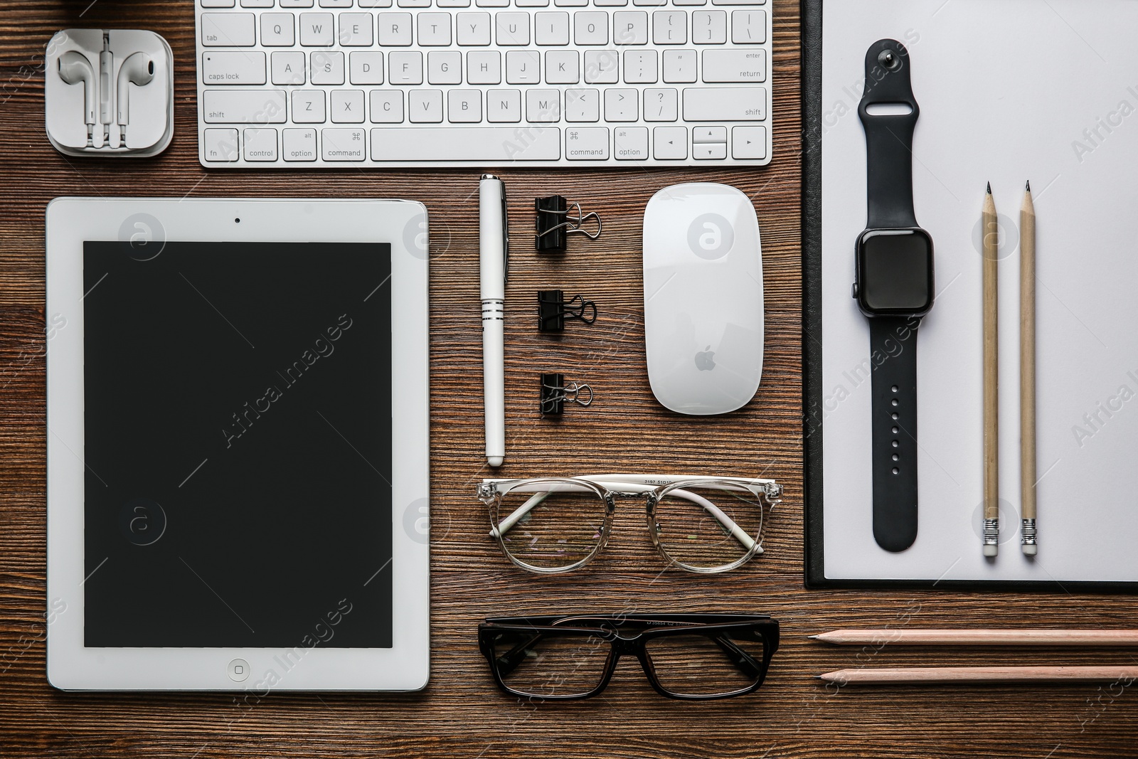 Photo of MYKOLAIV, UKRAINE - JULY 20, 2020: Flat lay composition with different Apple gadgets on wooden table