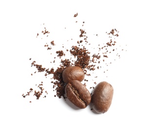 Photo of Coffee grounds and roasted beans on white background, top view