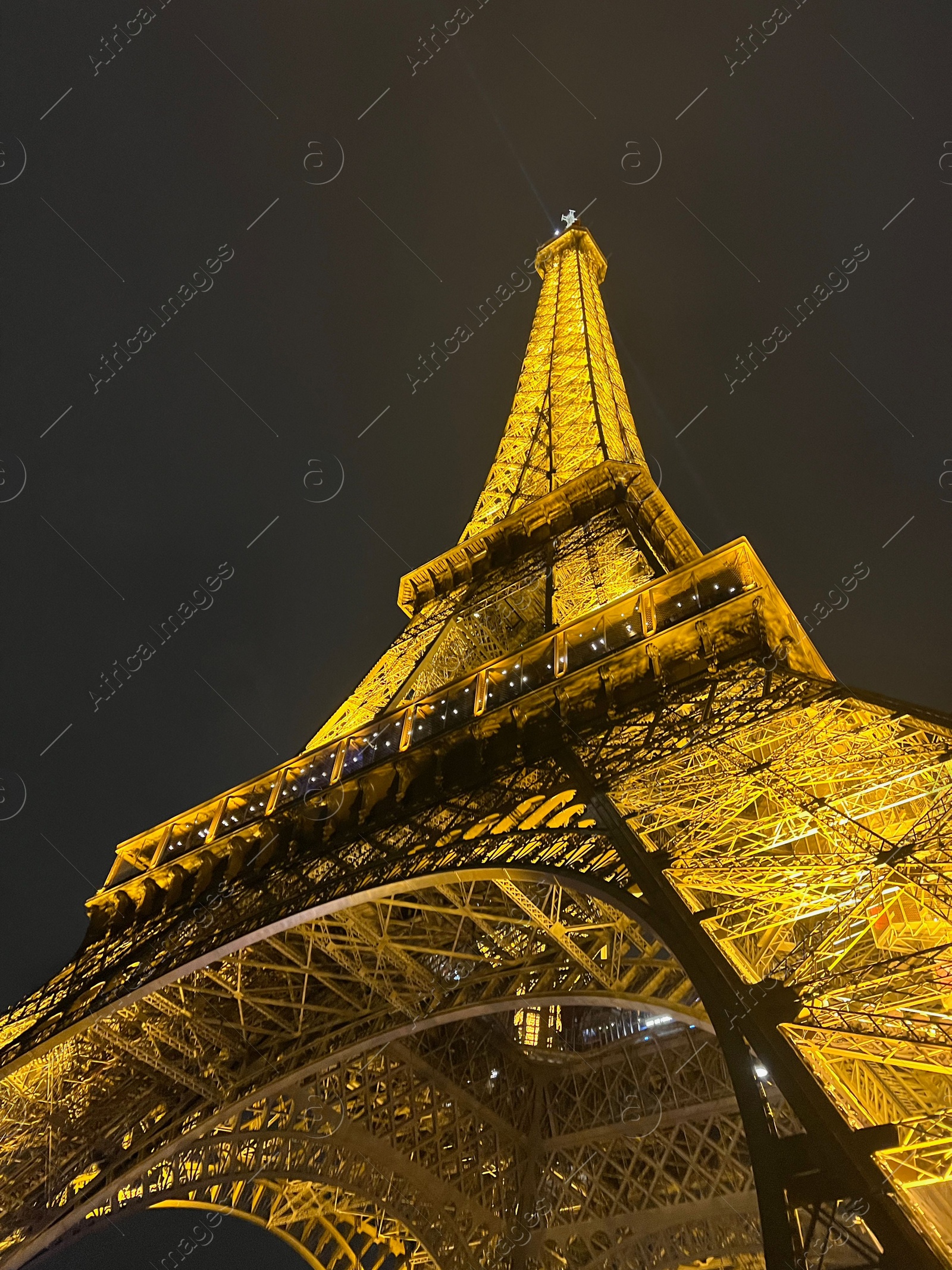 Photo of Beautiful illuminated Eiffel tower against night sky, low angle view