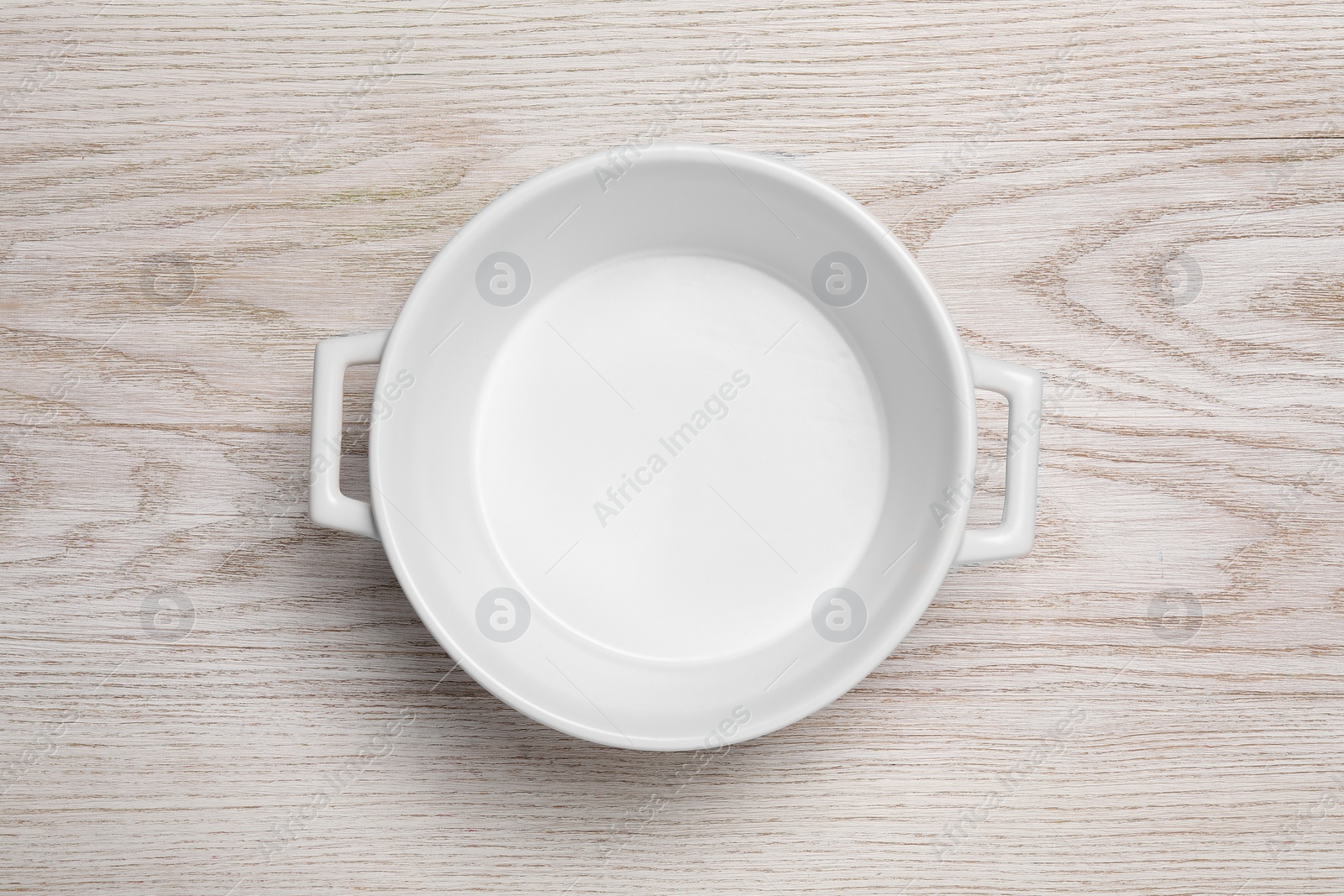 Photo of One empty pot on white wooden table, top view