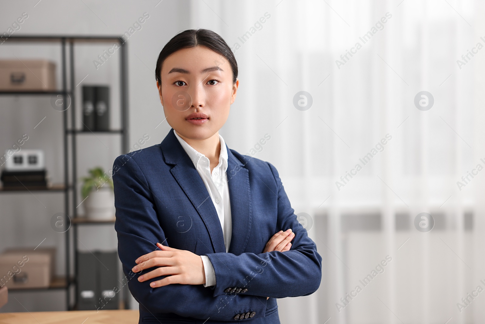 Photo of Portrait of notary with crossed arms in office. Space for text