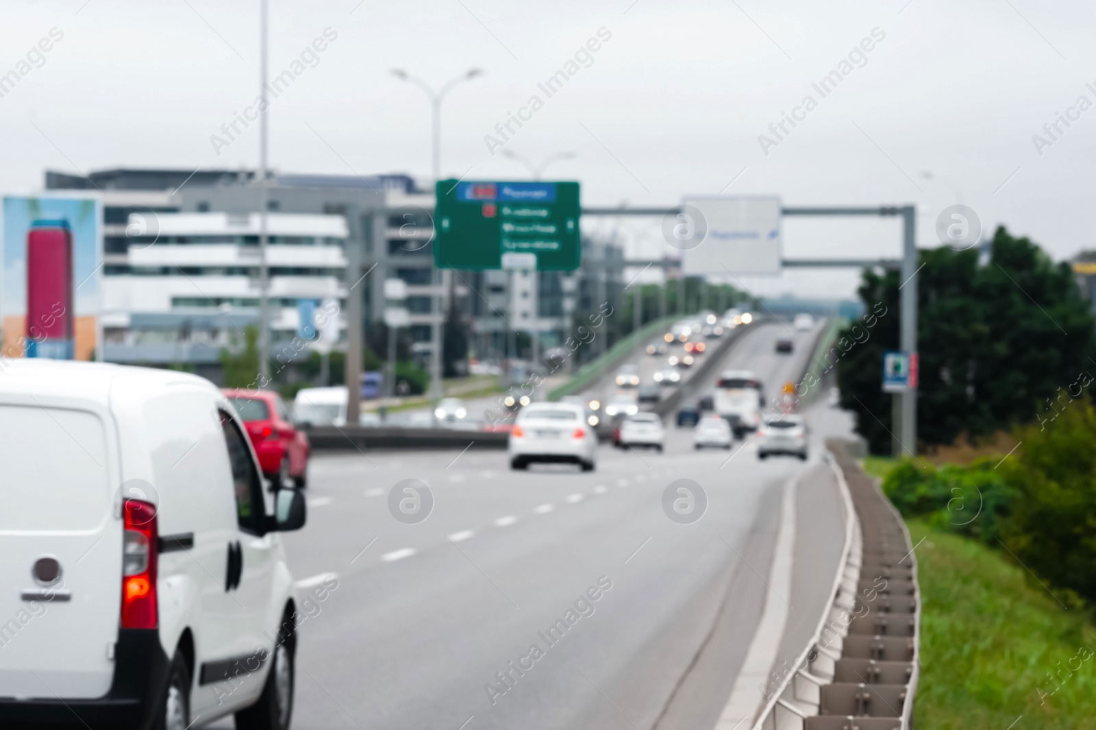 Photo of Blurred view of city road with cars