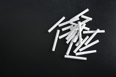 Pieces of chalk on blackboard, top view