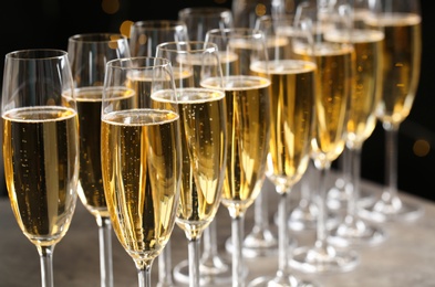 Photo of Glasses of champagne on table, closeup. Space for text