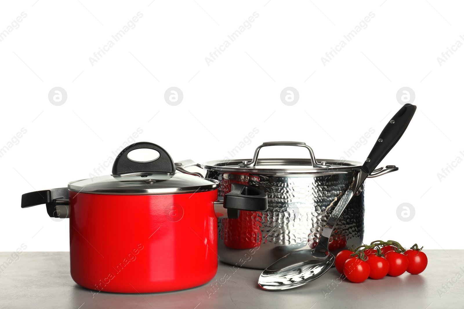 Photo of Composition with clean saucepans on table against white background, space for text