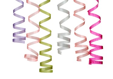 Many colorful serpentine streamers on white background