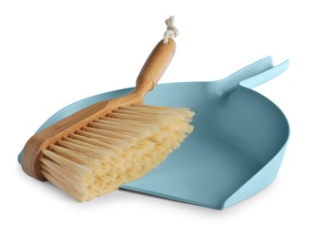 Light blue dustpan and wooden brush on white background